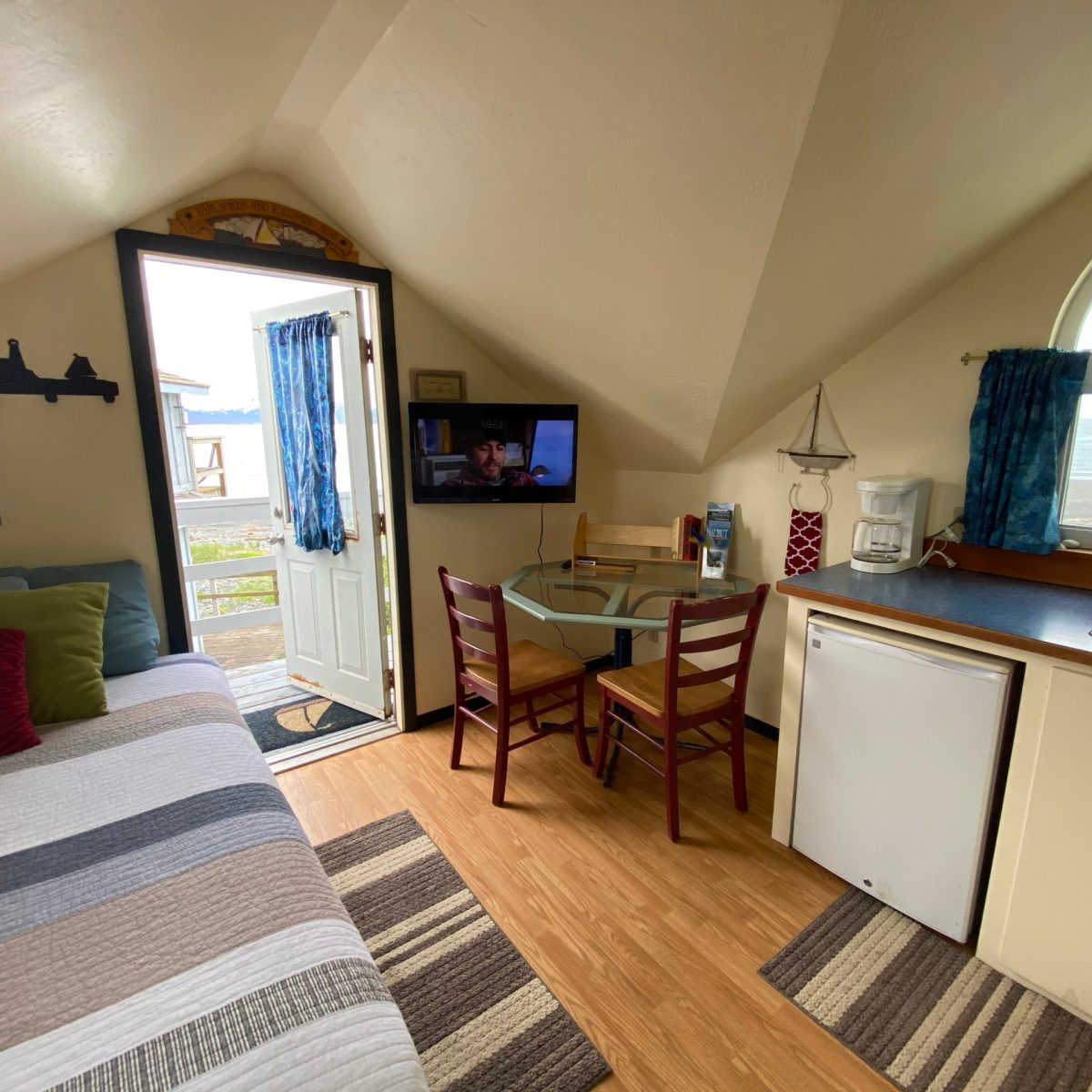 a bedroom with a bed and desk in a room