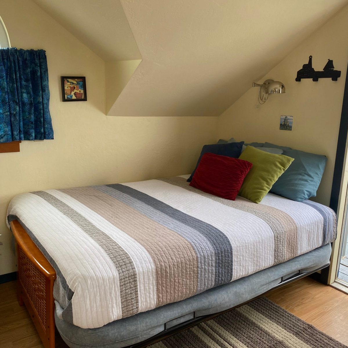 a bedroom with a bed and desk in a room