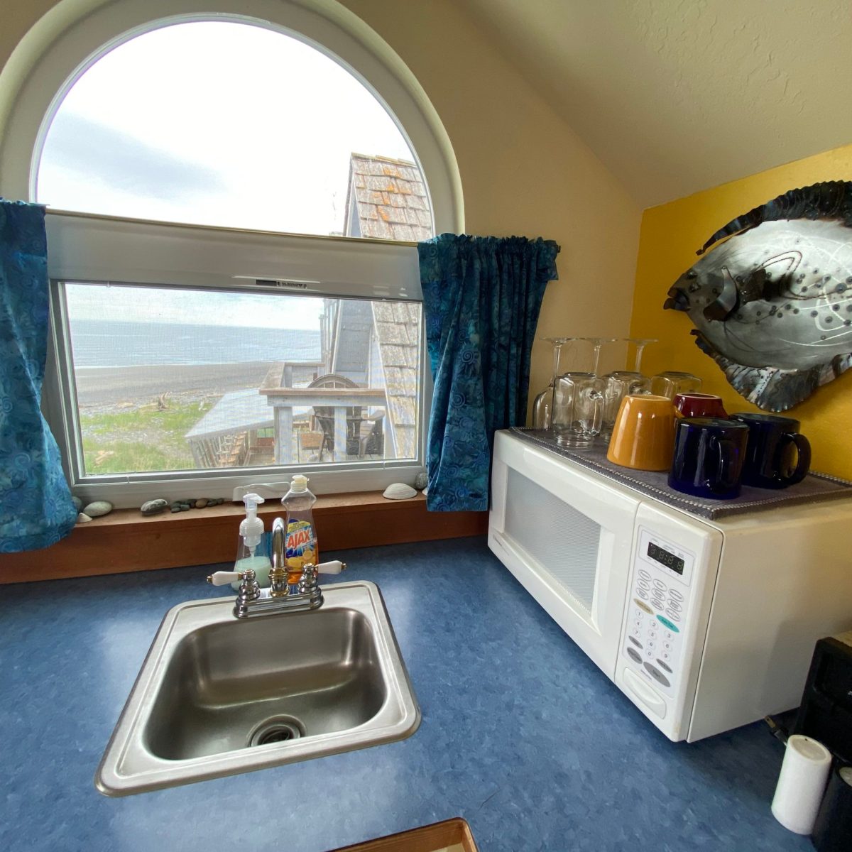 a living area with a sink and a mirror