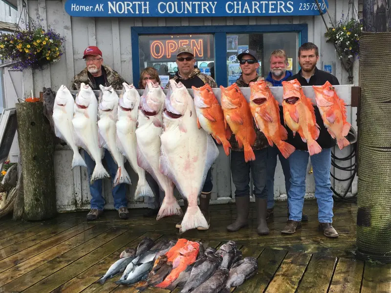 a group of people posing for a fish