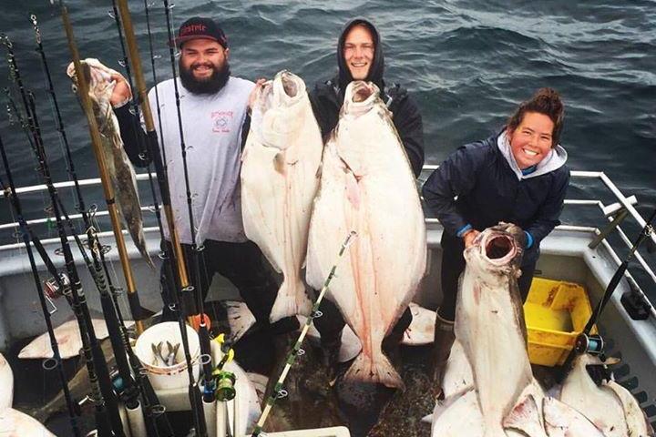 a group of people standing next to a body of water
