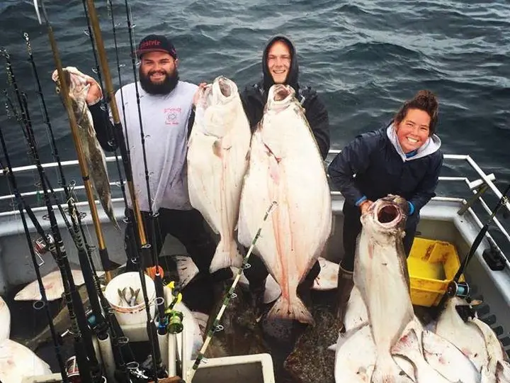 a group of people standing next to a body of water