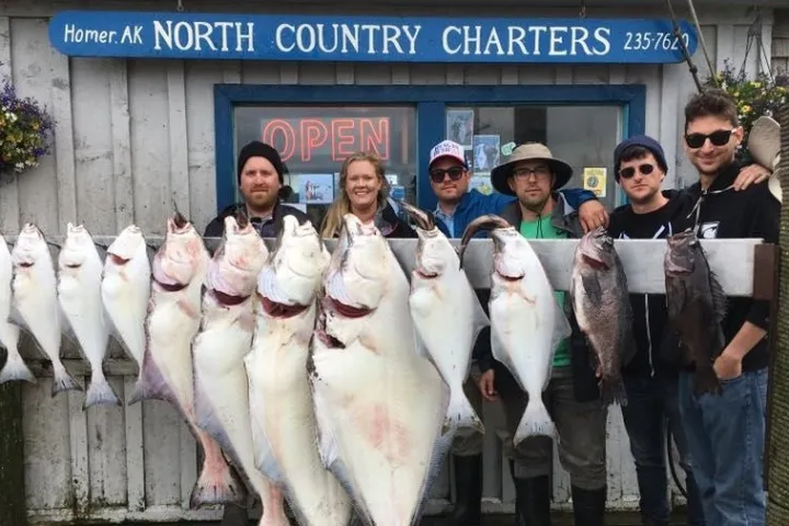 a group of people standing in front of a fish