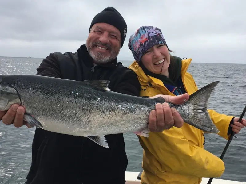 a man holding a fish in the water