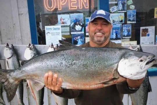 a man holding a fish