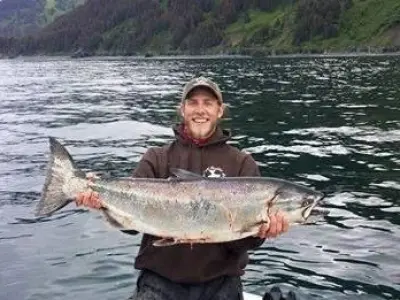 a person holding a fish in the water