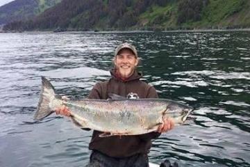 a person holding a fish in the water