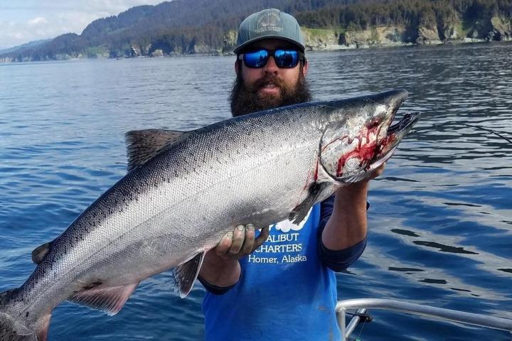 a man holding a fish swimming under water