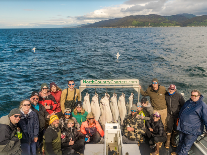 a group of people standing in front of water