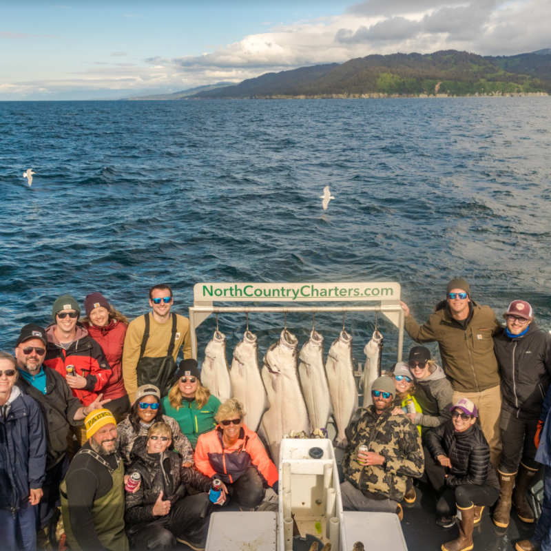 a group of people standing in front of water