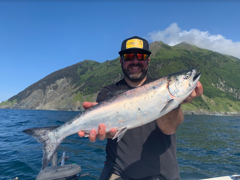 a person holding a fish in the water