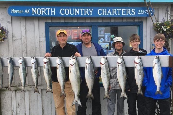 a group of people standing in front of a fish
