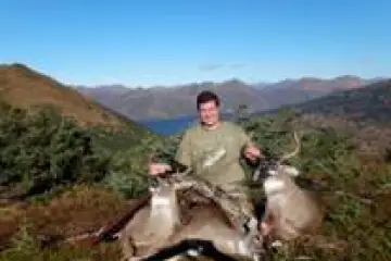 a man riding a horse with a mountain in the background