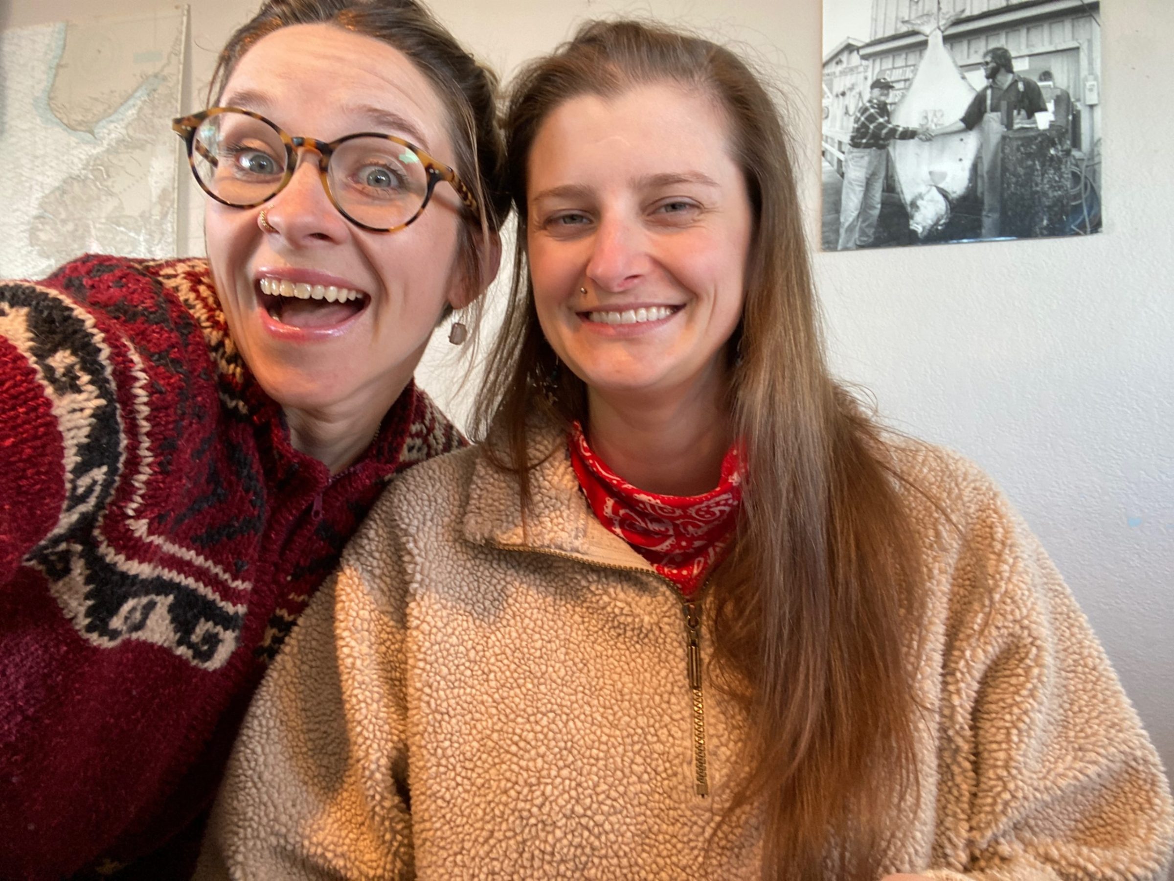 a person wearing glasses and smiling at the camera