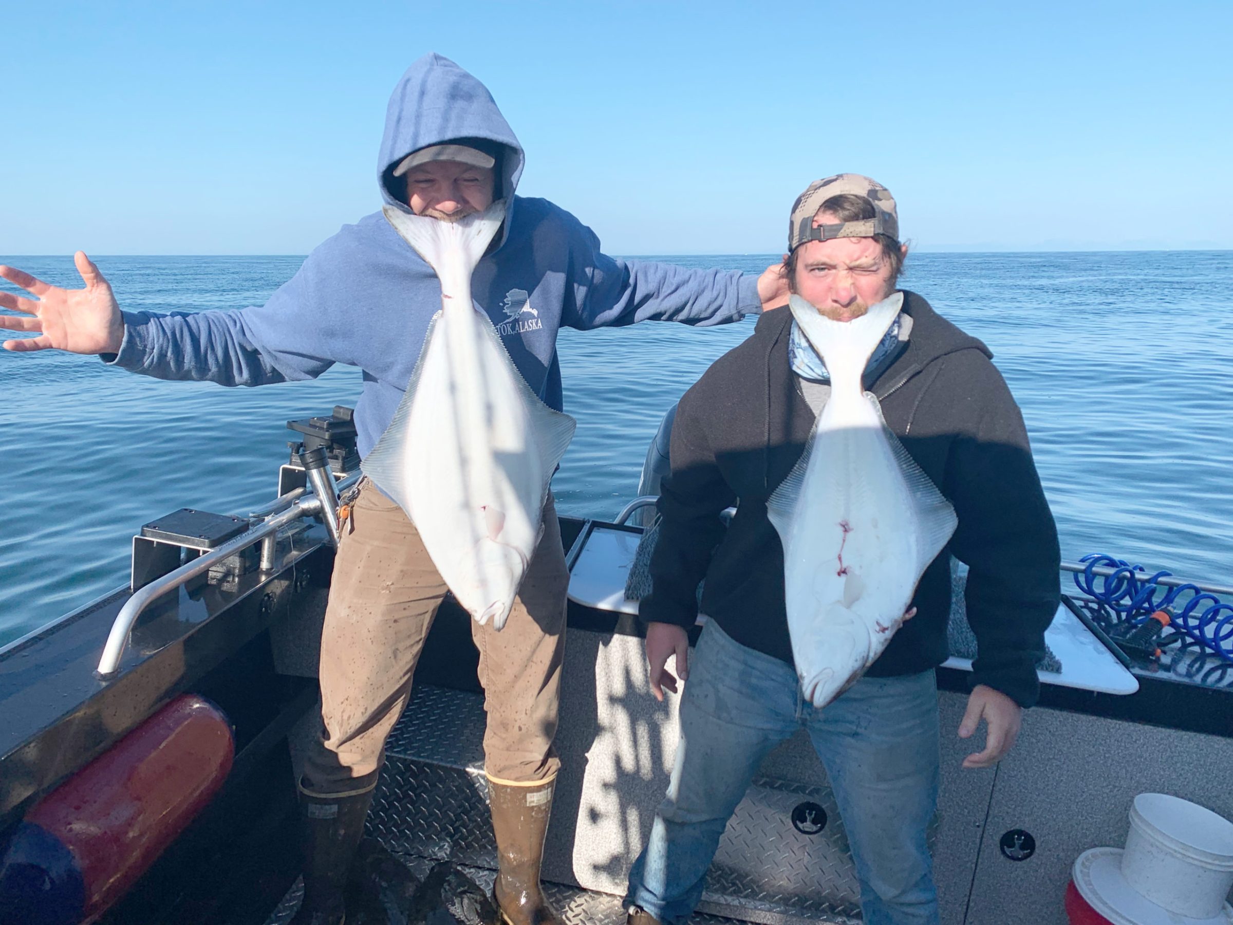 a couple of people standing next to a body of water